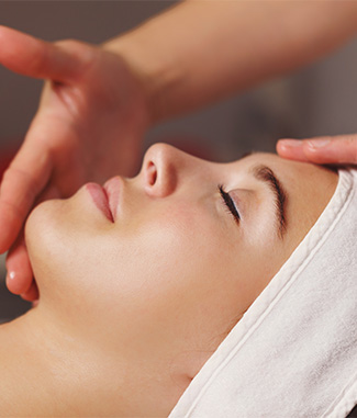 Image of a woman getting a facial at a spa.